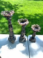 All three candle holders with wreaths displayed outdoors