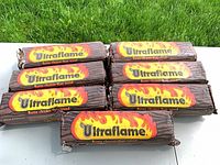 Seven Ultraflame firelogs laid out showing logo side