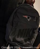 Front view of gray Nike backpack with Patriots logo, showing logos and pockets