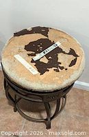 Stool with seat covering mostly missing exposing foam, showing frame design