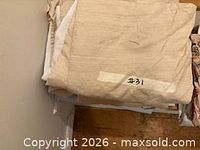 Folded beige fabric drapery panels labeled #31