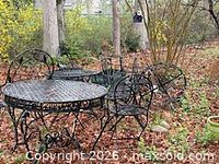 Patio set showing round table, chairs, bench in garden