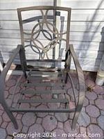 Front view of one chair showing decorative back and seat slats