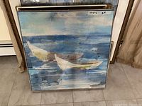 Front view of framed canvas print showing two boats on blue water