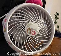 Front view of white USB desk fan showing spiral grill and decorative stickers