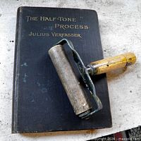 Front cover of book with ink roller laying across