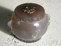 Top view showing 10k gold double-headed eagle emblem on agate surface