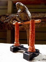 Front view of brass parakeet inkwell on wooden perch
