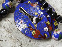 Close-up of cloisonné pendant and adjacent beads