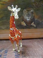 Front view of enameled giraffe trinket box
