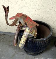 Elephant sculpture positioned inside ceramic planter