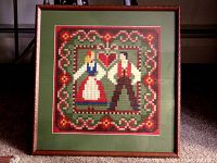 Front view of framed needlepoint showing full design