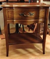 Front view showing full table, drawer, shelf, legs