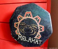 Front of octagonal drum showing painted Malahat sun motif and signature