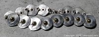 Full view of linked hammered discs with central studs