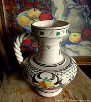Full view of pitcher showing floral decoration and twisted handle