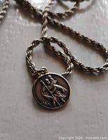 Close view of sterling St. Christopher pendant on rope chain