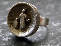 Front view showing raised figure and textured bezel