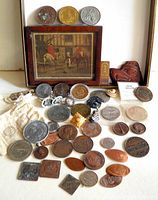 Overview of coins tokens framed print carved ornament and pouch