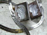 Close-up of abalone Roman soldier cufflinks and sterling snake chain