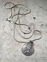 Pendant and chain laid out showing overall appearance