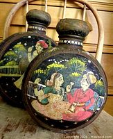 Front view of both gourd vessels with painted courting scenes