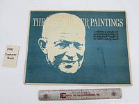 portfolio cover "The Eisenhower Paintings" with ruler for scale