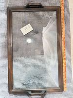 Full view of rectangular glass tray with wood frame and handles, ruler alongside