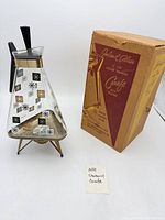Carafe on warming stand beside original box
