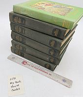 Stack of six My Book House books with ruler for scale