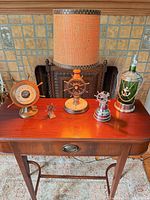All five nautical items arranged on small wooden table in front of fireplace