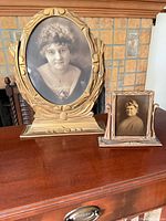 Both framed portraits on surface showing relative sizes and design