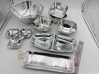 All ten aluminum serving pieces arranged together