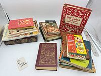 Overall lot showing stacks of more than twenty cookbooks in varied bindings with several identifiable titles