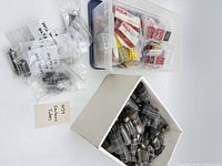 Overview of boxed and loose vacuum tubes in two containers
