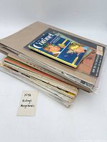 Stack of assorted magazines, top item Coronet