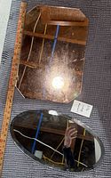 Rectangular and oval mirrors next to yardstick showing size and condition