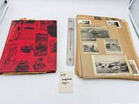 Album and stack of loose pages beside ruler showing size