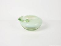 Overall view of mint green cased glass bowl with applied swirl handle