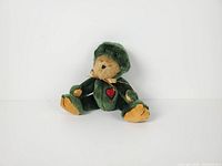 Front view of Boyds Bear Taddley in green frog costume showing overall appearance, ribbon, heart patch