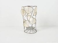 Full view of cylindrical capiz shell and metal hurricane candle holder