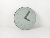 Front view of sage green Slipsten wall clock