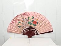 Full view of unfolded fan showing painted scene and size