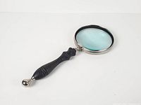 Full view of magnifier showing lens, frame, and handle