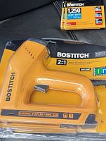 Front view of sealed package showing stapler/nail gun and 1⁄4 in staple pack
