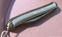 Closed knife, nickel-plated handle side profile with lanyard ring