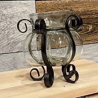 Front angled view showing glass vessel and scroll metal frame