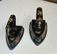 Top view of both hand-painted flat irons showing floral artwork and handle design