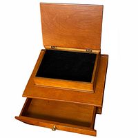 Lid open showing black velvet-lined compartment and extended bottom drawer