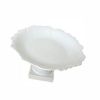 Top view of the compote showing scalloped rim and white porcelain surface